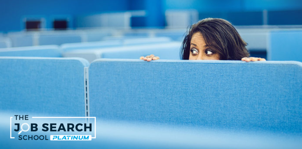 Woman in office peaking over her cubicle wall as a metaphire for jb sekers tapping into the hidden job market