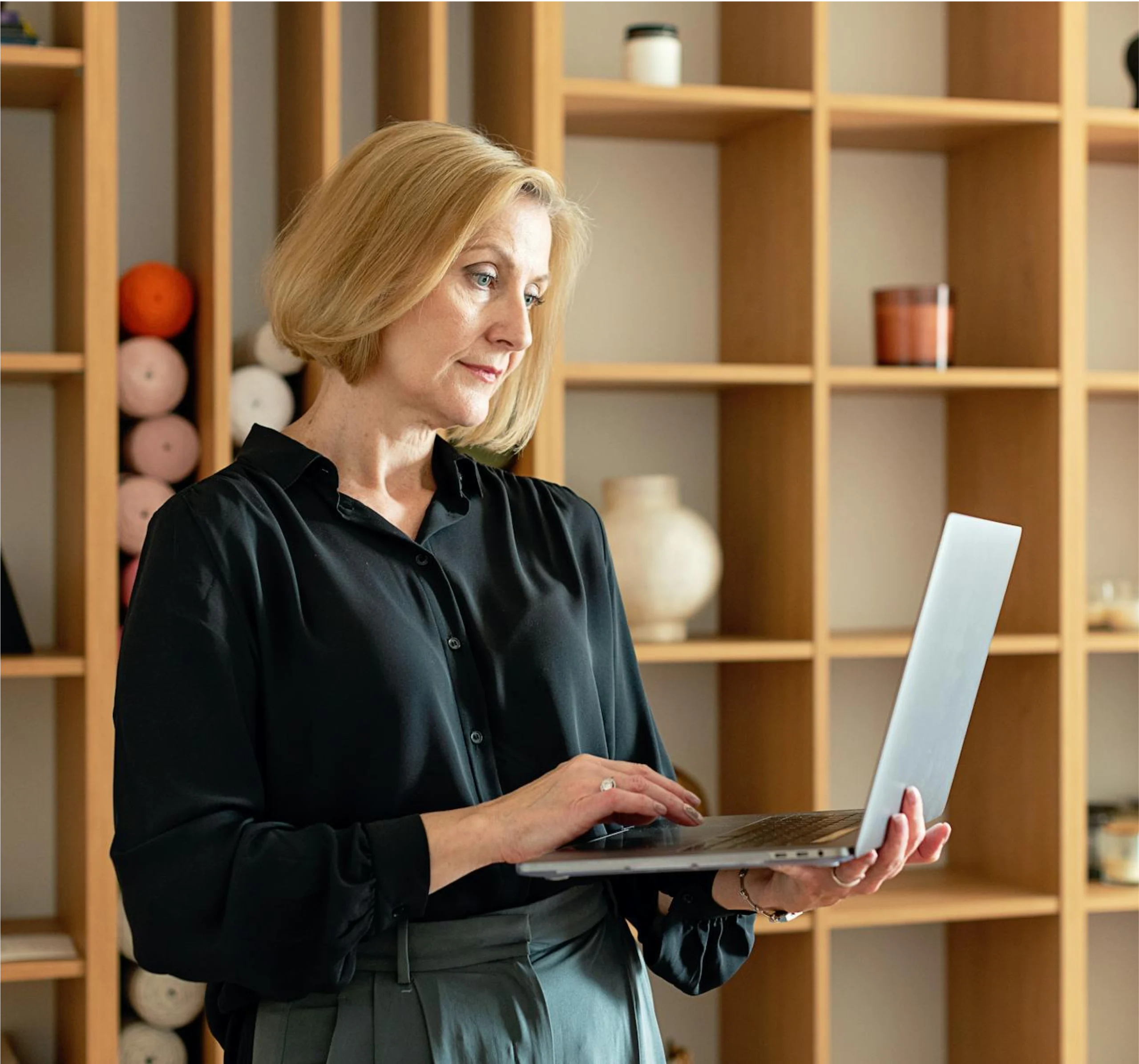 Professional woman working on laptop in modern office space